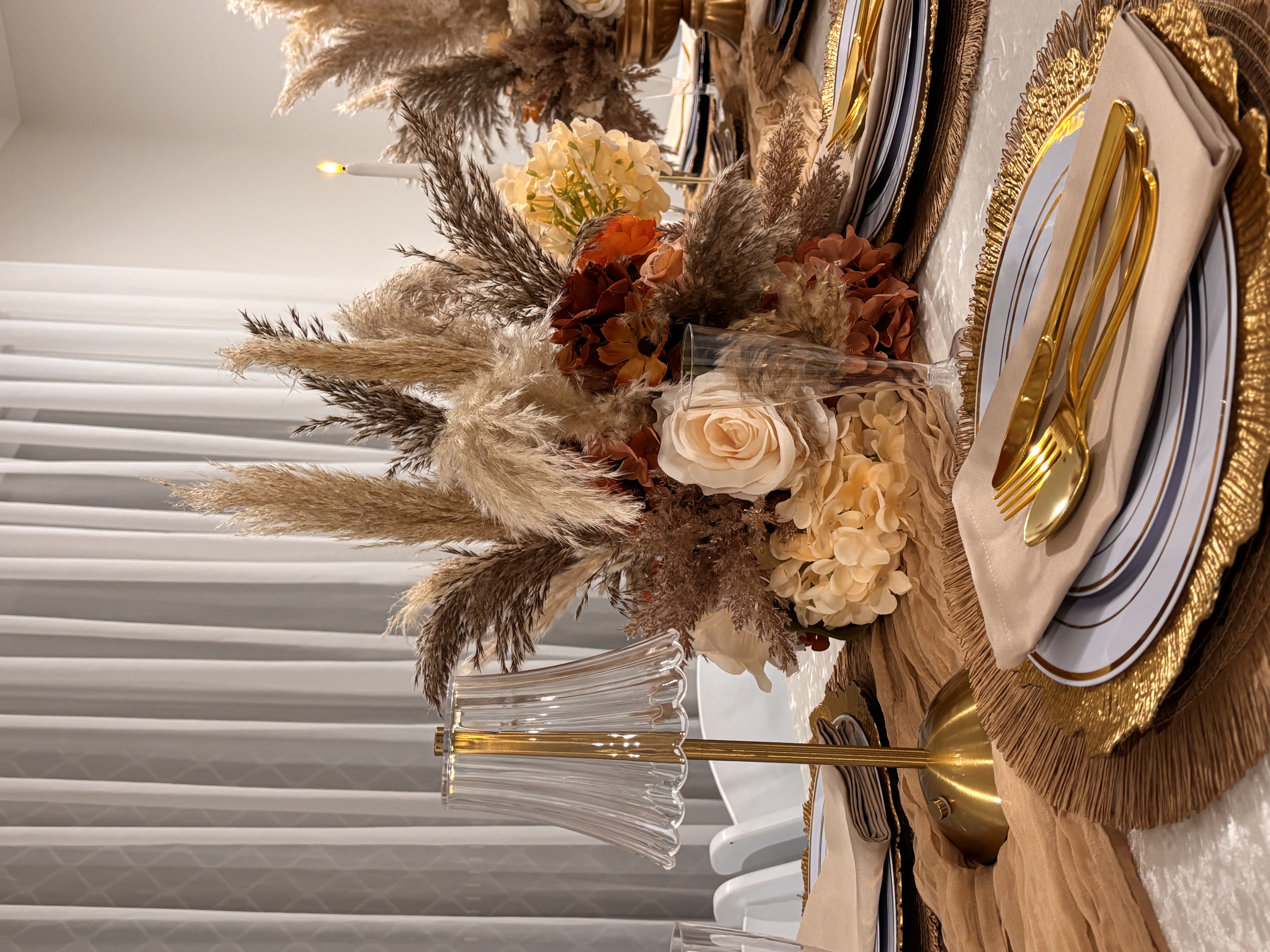 Boho wedding backdrop close-up with white plinth, candles and autumn florals