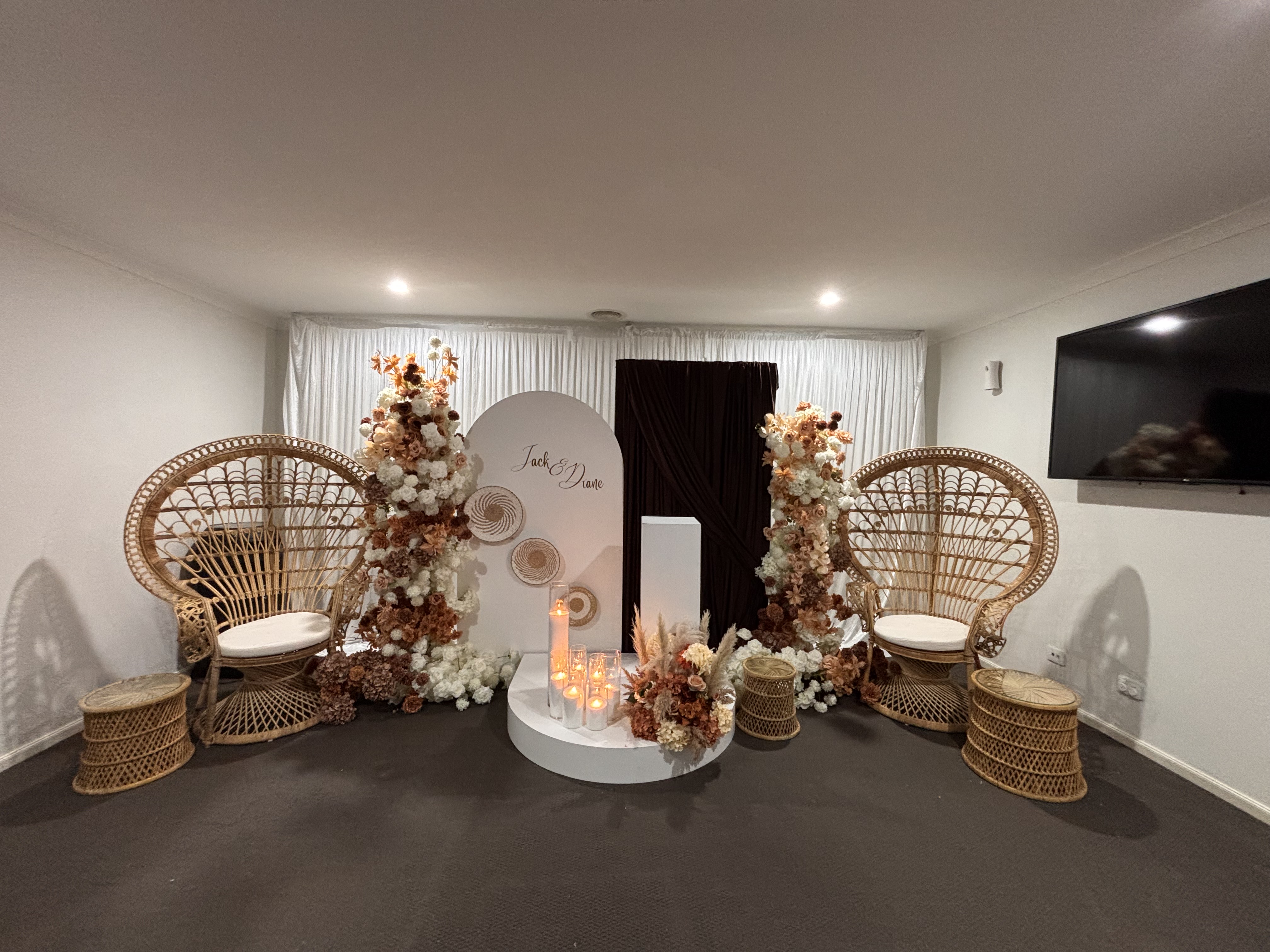 Jack and Diane boho wedding full stage setup with both peacock chairs, floral arches and round backdrop