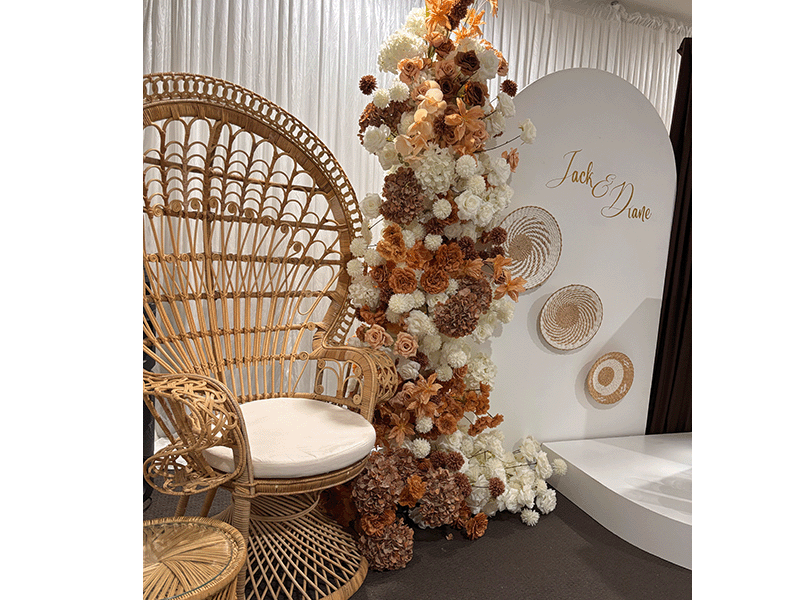 Single peacock chair with boho floral arch and Jack and Diane round backdrop